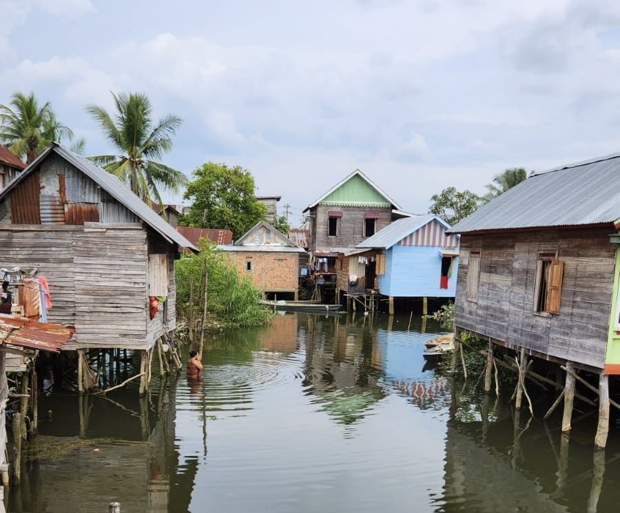 Colourful timber stilt houses standing over water